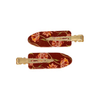 2 pack snap hair clips in Ember Floral, a matching pair of cream acrylic clips with a warm red floral print and gold tone metal hardware, on a white background.
