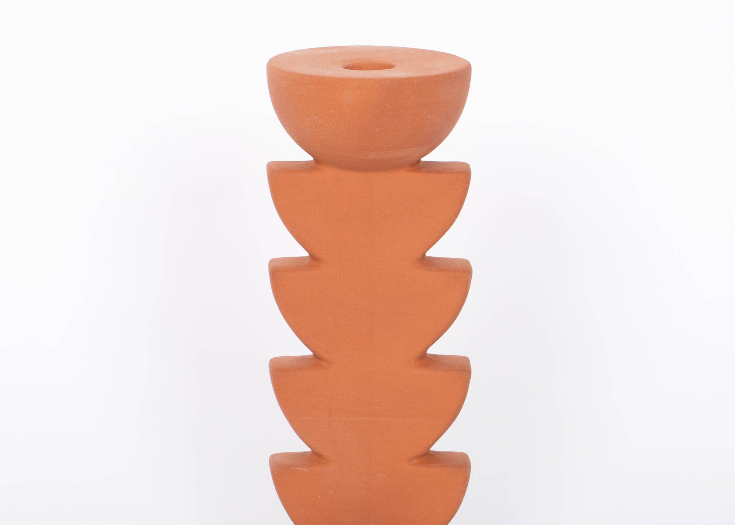 Cadwell Candle Holder stacked half moon design in natural terracotta for taper candles. White background.