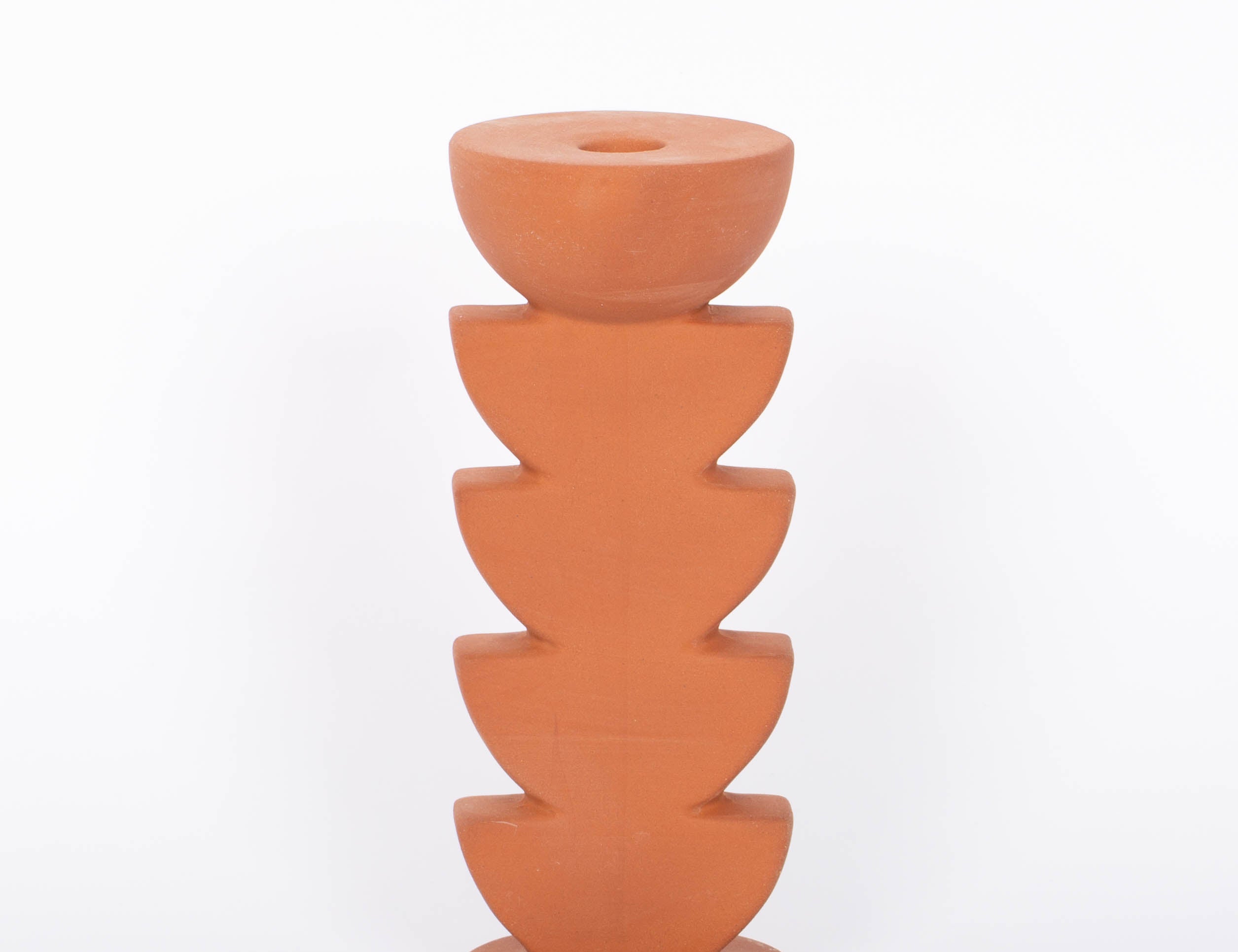 Cadwell Candle Holder stacked half moon design in natural terracotta for taper candles. White background.
