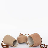 Red brown stoneware Canyon Clay Bells with leather hangings. Set of 3 sizes for indoor and outdoor. White background.
