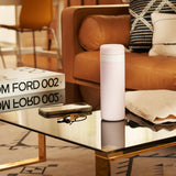 Blush wide mouth ceramic Porter waterbottle on coffee table in luxury living room with TOM FORD book, phone, keys, and bag. 