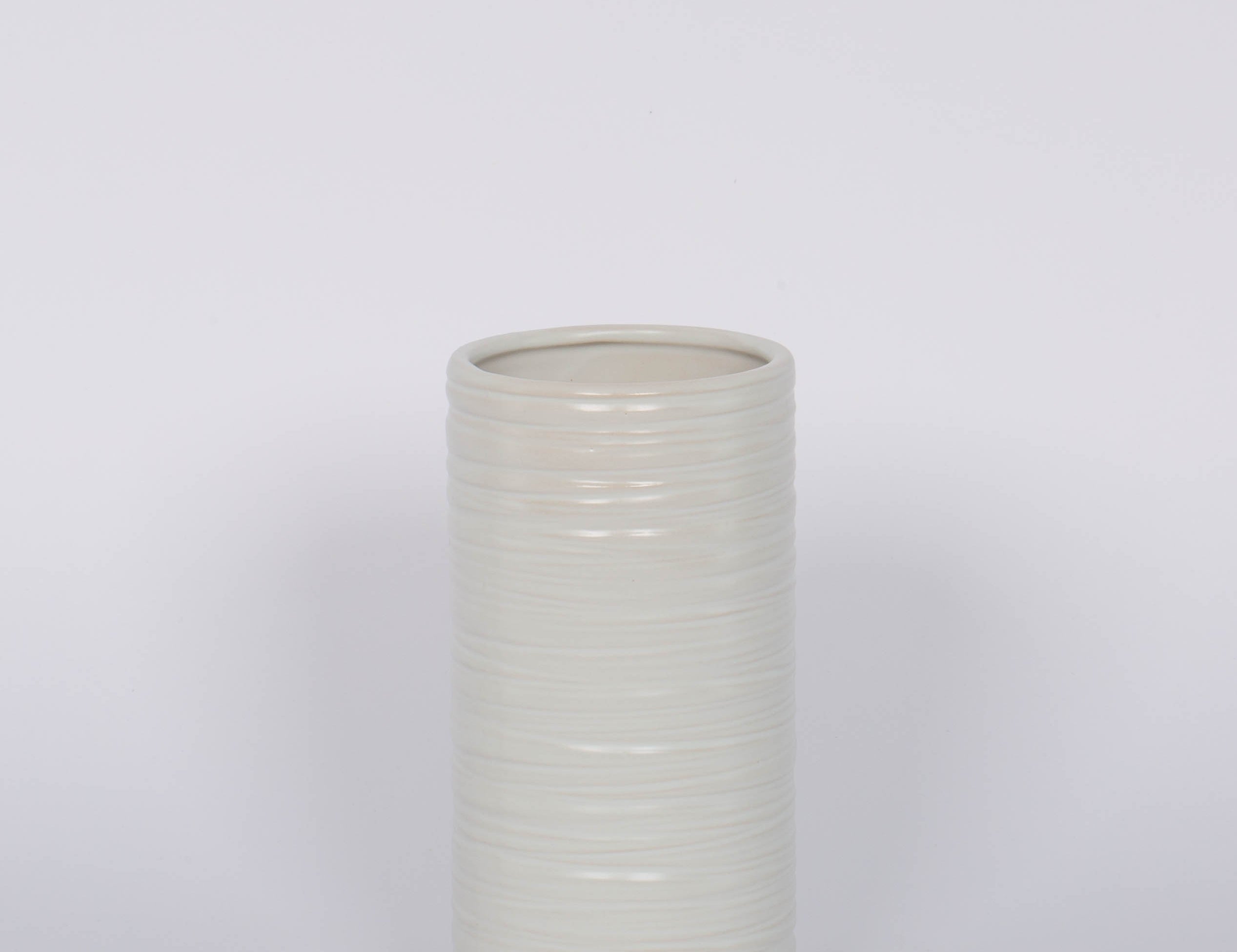 Modern and striated tall ceramic Everest Pot in a matte white glaze.White background.