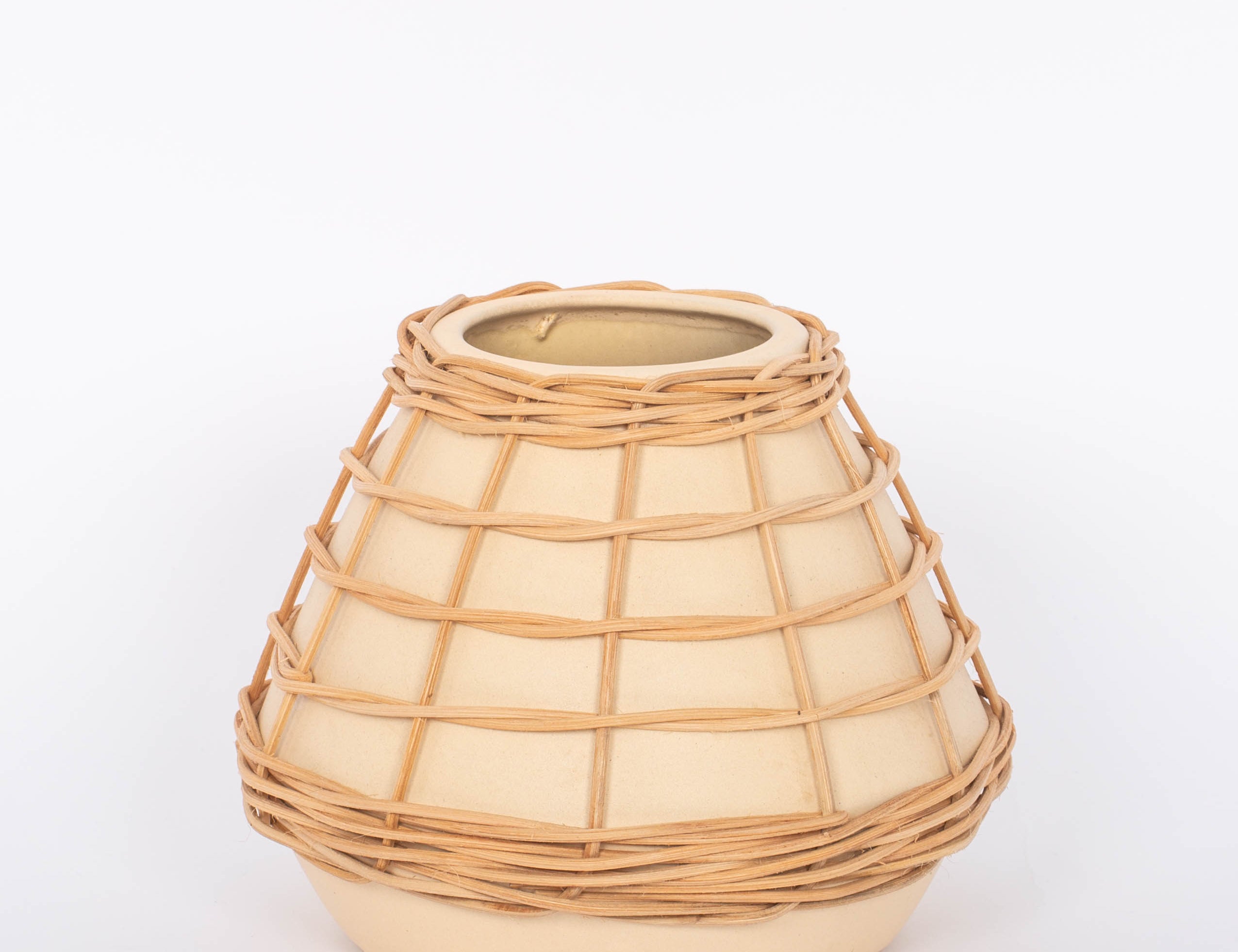 Lissome Tan Vase speckled neutral toned earthenware and woven rattan accents. White background.
