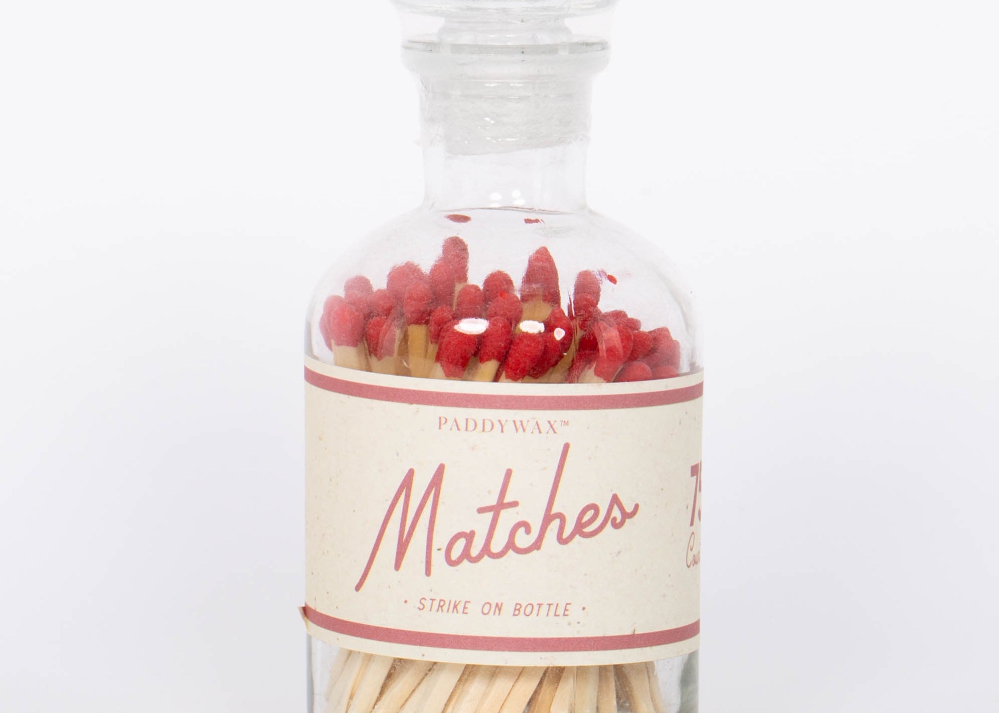 Red Safety Matches by Paddywax with match striker on back of clear glass bottle and red match tips.