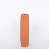 Tall oval Poppy Budvase in terracotta geometric silhouette with imprint of live plant. Side view. White background.
