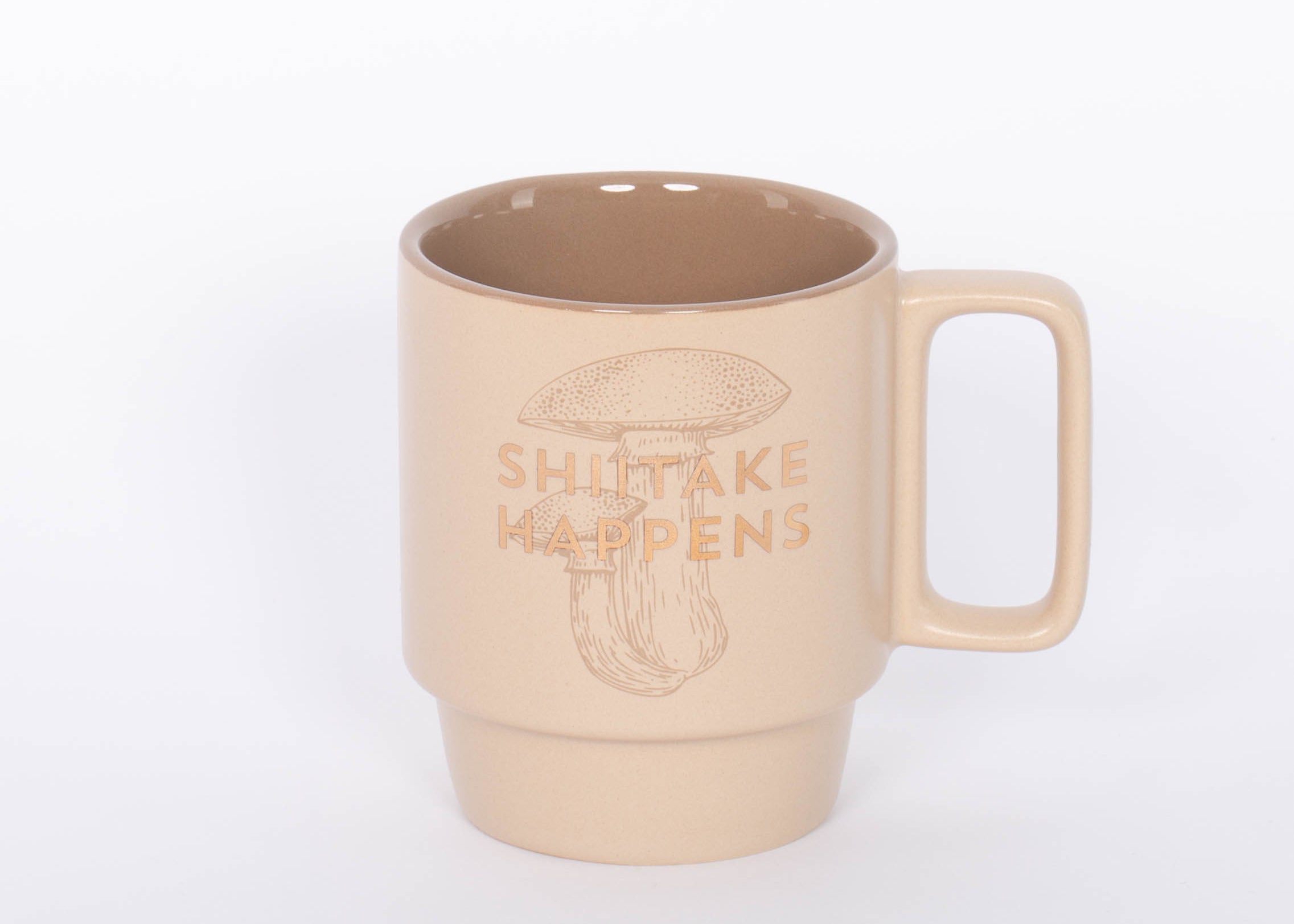 Shiitake Happens Mug. Crafted of high-quality ceramic, this stackable mug features a sassy sentiment in metallic gold lettering. This 12 oz. mushroom mug is the perfect companion to your morning routine whether it's for a cup of coffee, hot cocoa, or tea. It also makes a great gift for the mushroom lover in your life!