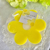 Beekman 1802 Bloom Bath Sponge, a bright yellow flower-shaped sponge with a Beekman tag
