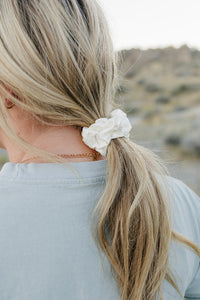 Low ponytail tied with the Desert Sol Mulberry Silk Scrunchie in Ivory