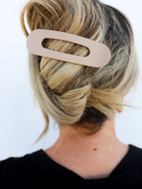 Kaxi Lay Down Claw hair clip in taupe holding a blonde twist, back view