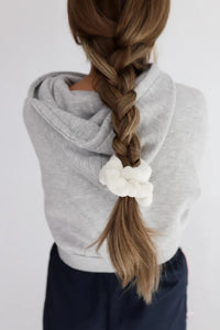 Kaxi Midi Towel Scrunchie in Cream tied at the end of a long braid, back view