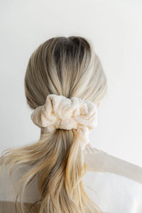 Kaxi Oversized Towel Scrunchie in cream worn in a low bun, back view