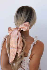 Kaxi Pink Plaid Hair Scarf tied in a bow around a blonde ponytail, back view