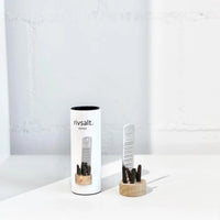 Rivsalt Pepper Stainless Steel Grater with long pepper on a wooden stand beside its white tube