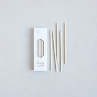 The Floral Society Wishing Candles in Parchment, thin cream taper candles beside their white box