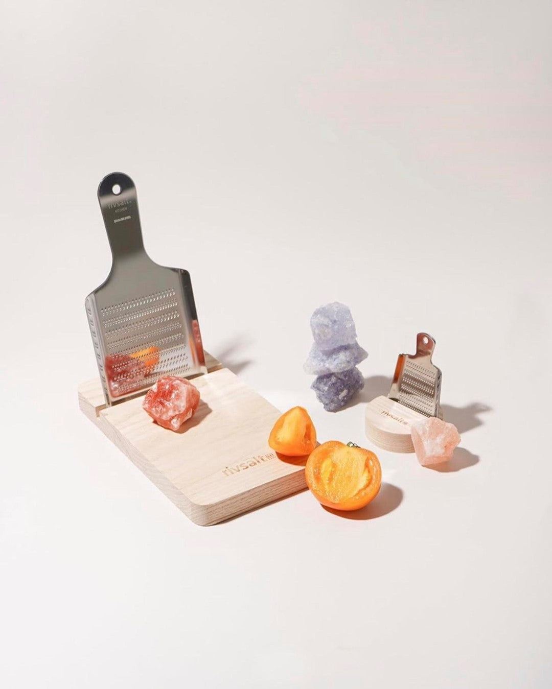 Himalayan Salt Rock Kitchen Grater and cutting board by Rivsalt with gemstones and orange tomato 