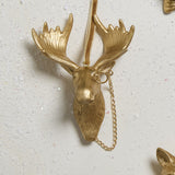 E + E Ornaments, fourth view, the gold moose with a monocle and chain on a white surface