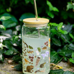 1canoe2 Flora & Fauna Glass Can with bamboo lid and straw in front of green foliage