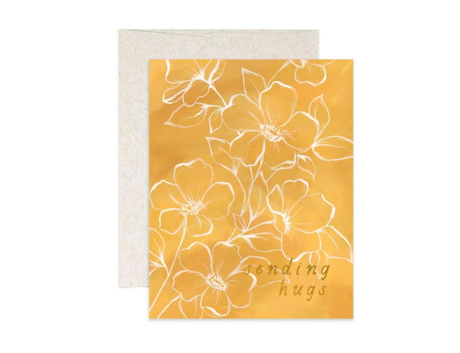 1canoe2 greeting card, golden yellow card with white line-drawn flowers reading Sending Hugs, with a natural kraft envelope
