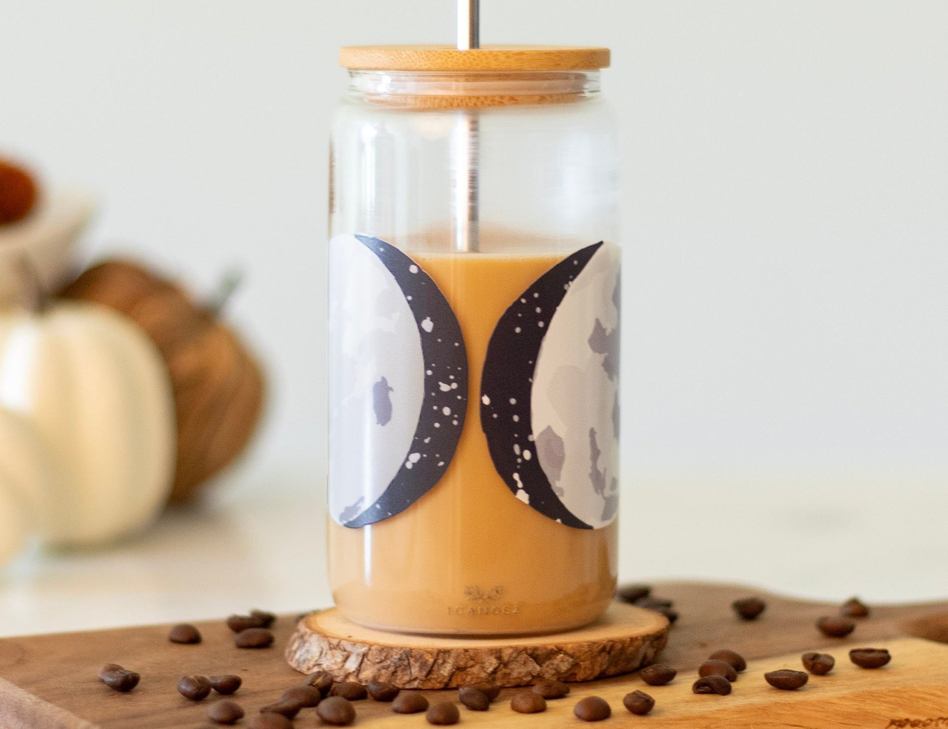 1canoe2 Moon Phases Glass Can with iced coffee on a wooden board with coffee beans