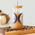 1canoe2 Moon Phases Glass Can with iced coffee on a wooden board with coffee beans