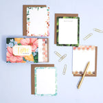 1canoe2 Trove Flat Notes with floral borders laid out with kraft envelopes and a gold pen