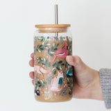 Hand holding the 1canoe2 Woodland Animals Glass Can filled with an iced coffee