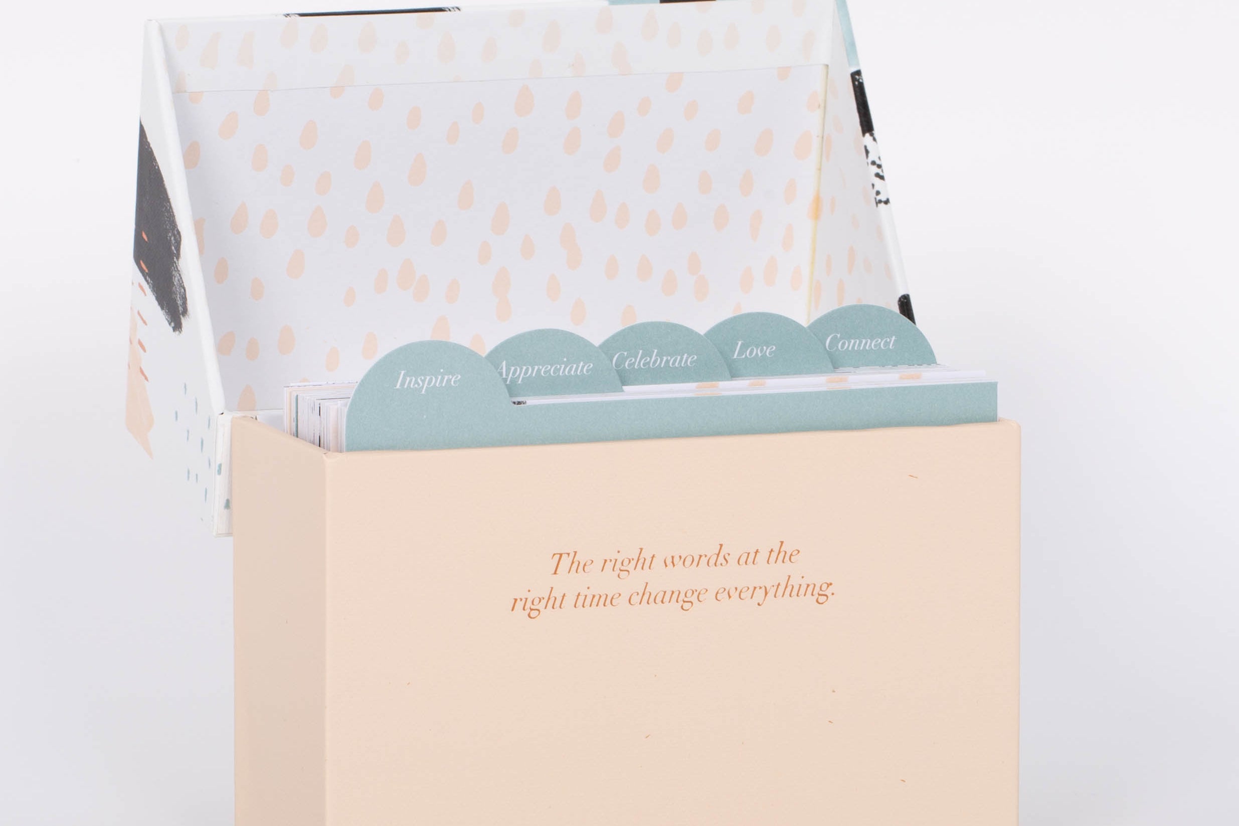 Open light pink box of 60 Beautiful Thoughts Postcards by Compendium. White background.