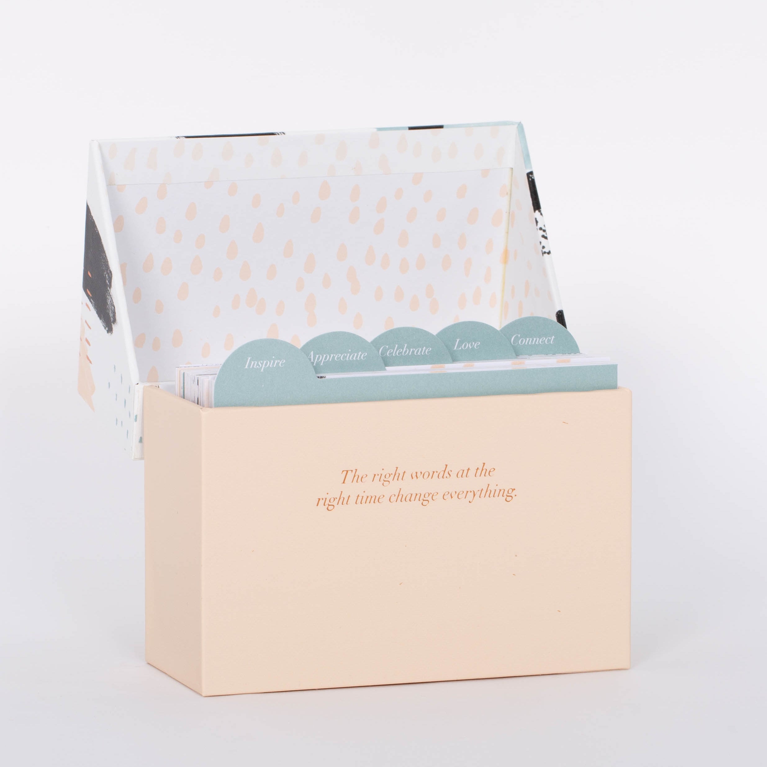 Open light pink box of 60 Beautiful Thoughts Postcards by Compendium. White background.