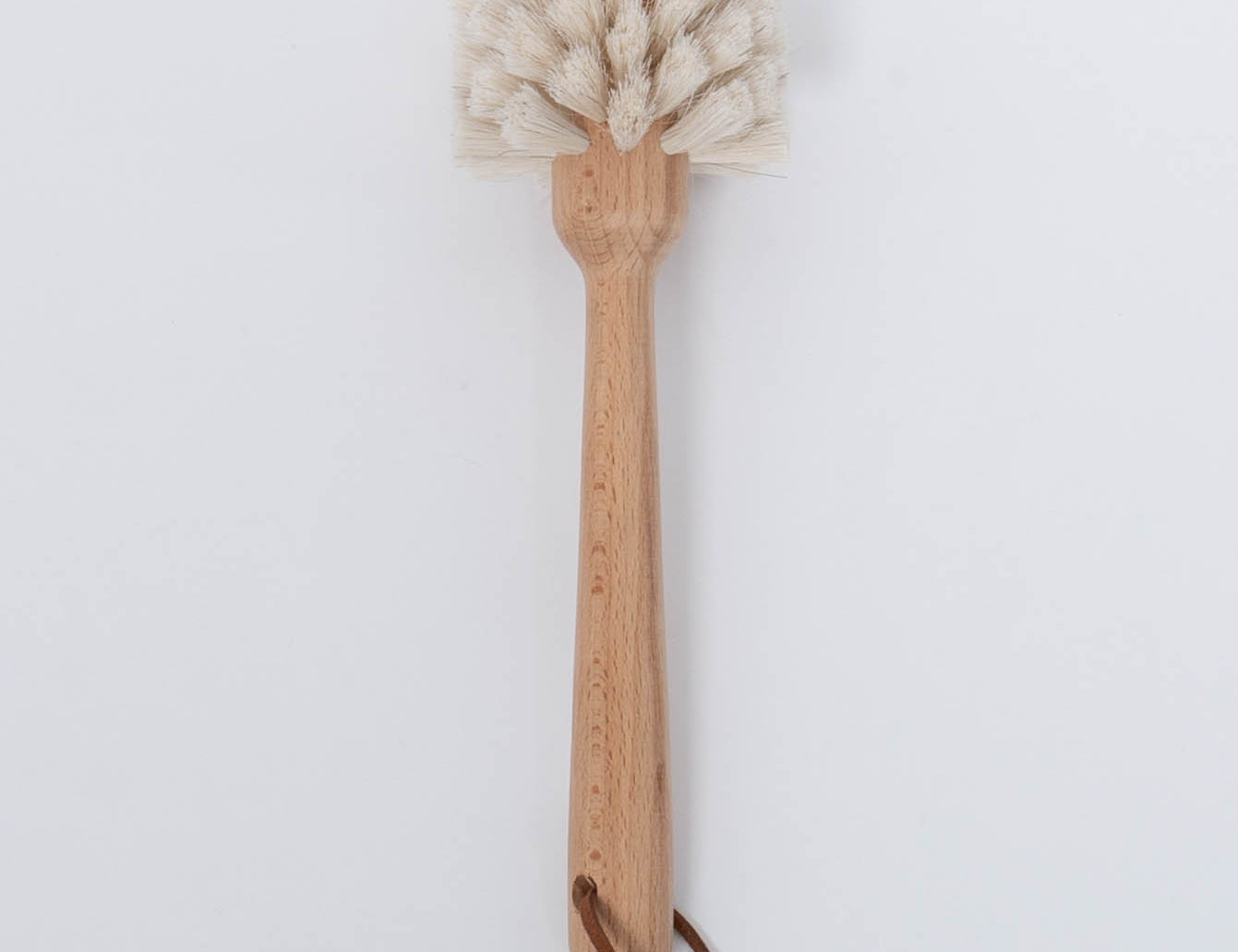 White bristle Beech Wood Dish Brush with Leather Strap by Creative Co-Op.