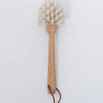 White bristle Beech Wood Dish Brush with Leather Strap by Creative Co-Op.