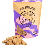 Bag of 'Berry Boost Bones' dog treats with visible treats on a white background
