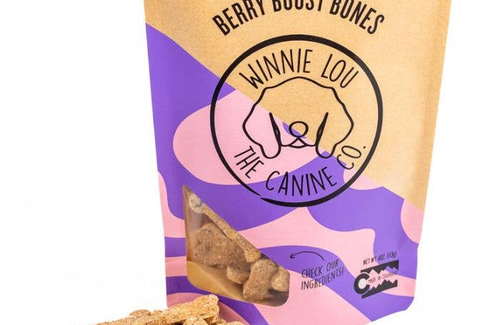 Bag of 'Berry Boost Bones' dog treats with visible treats on a white background