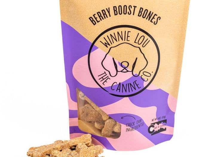 Bag of 'Berry Boost Bones' dog treats with visible treats on a white background