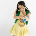 Woman holding a cat and a book on a white background