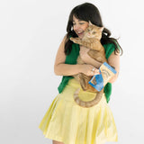 Woman holding a cat and a book on a white background
