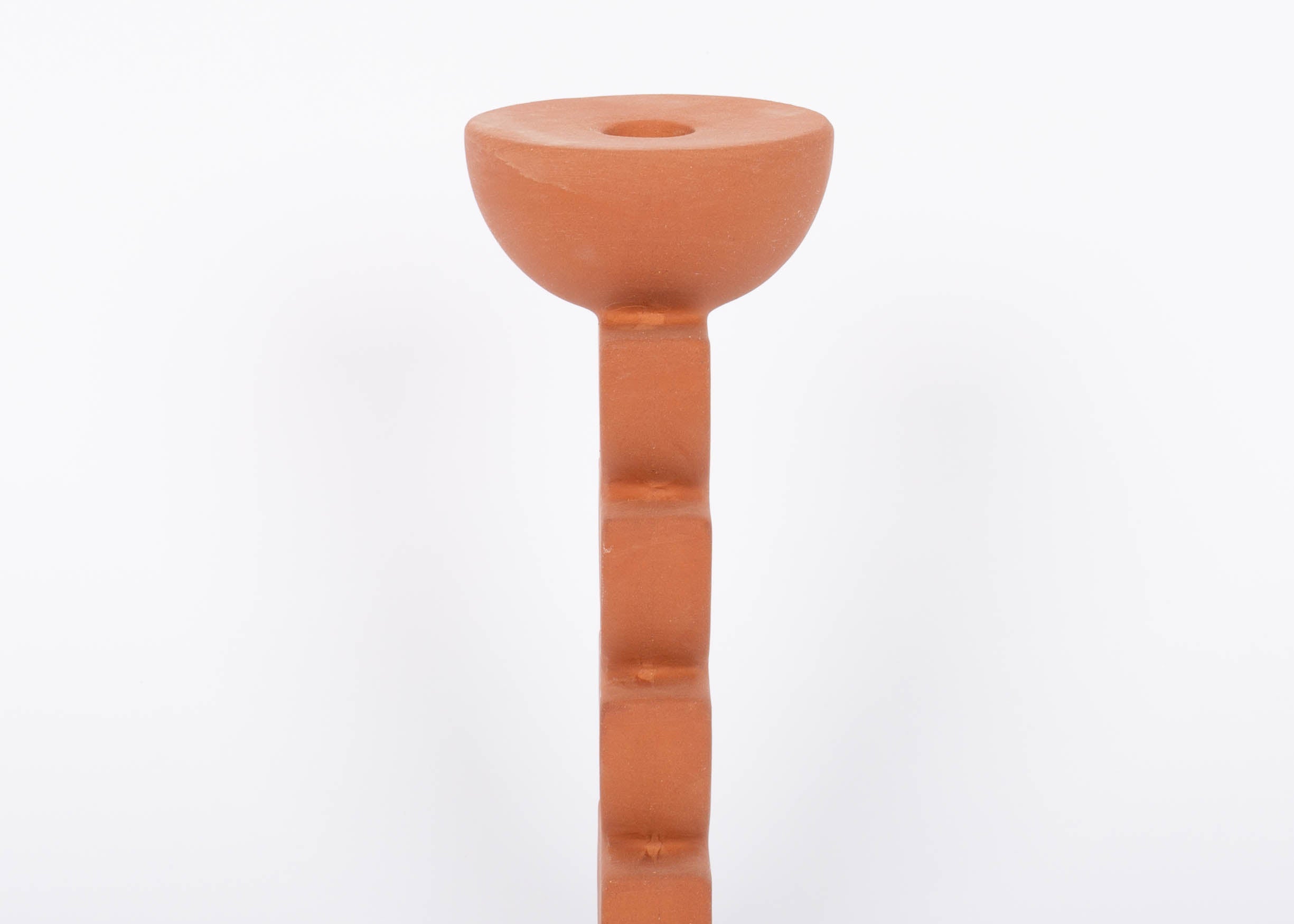 Cadwell Candle Holder stacked half moon design in natural terracotta for taper candles. Side view. White background. 