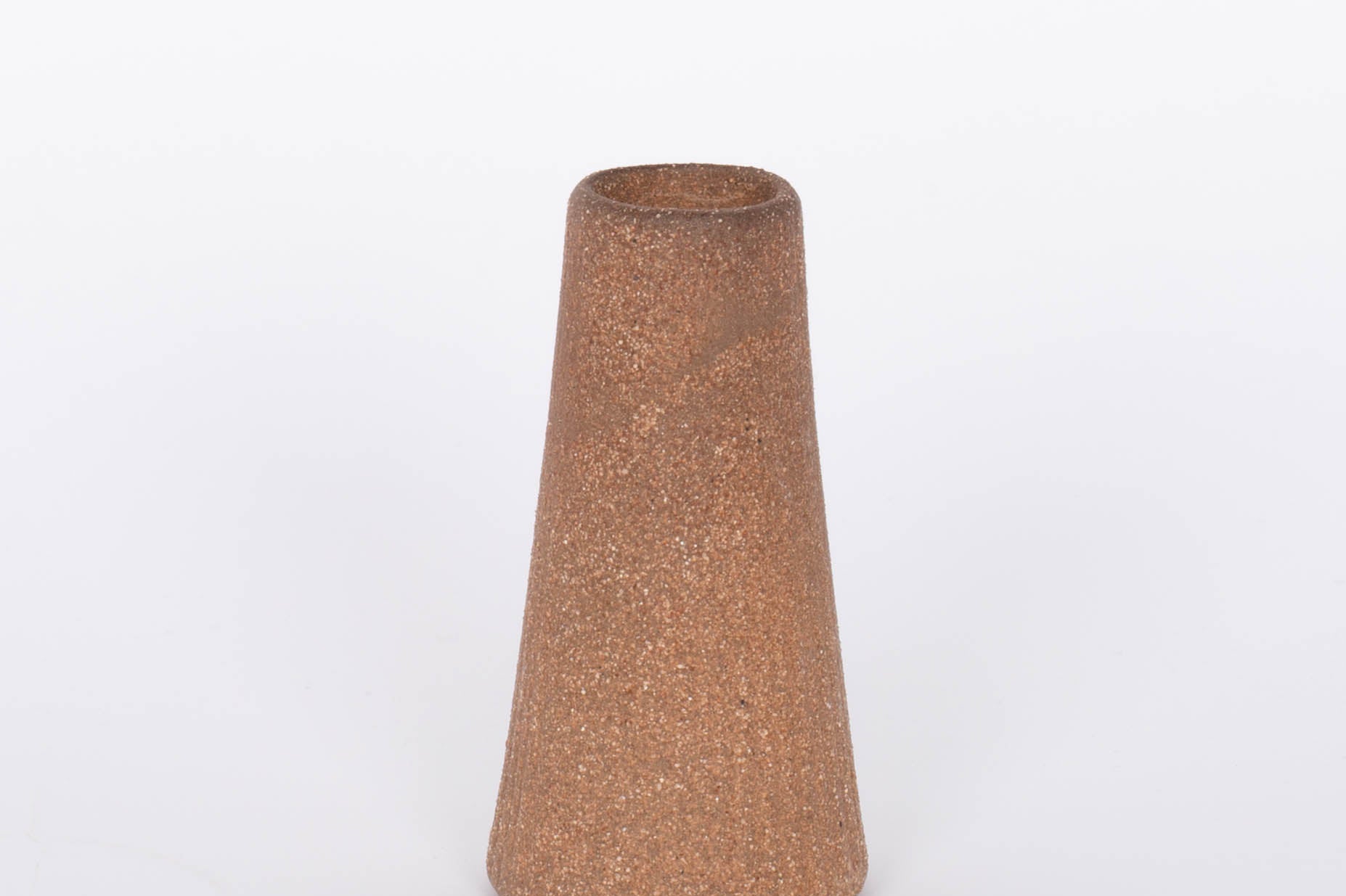 Reddish brown terracotta Canyon Candleholder base by Citrine. White background.
