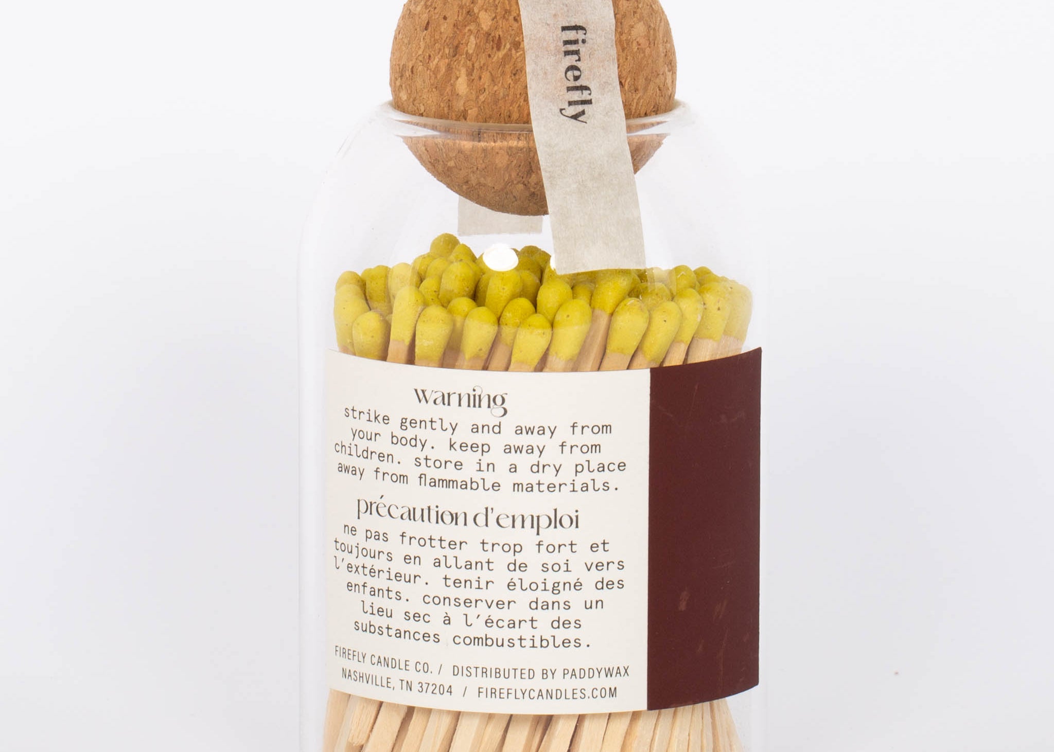 Yellow tip Safety Matches by Paddywax in clear jar and cork ball lid and match striker on back. 