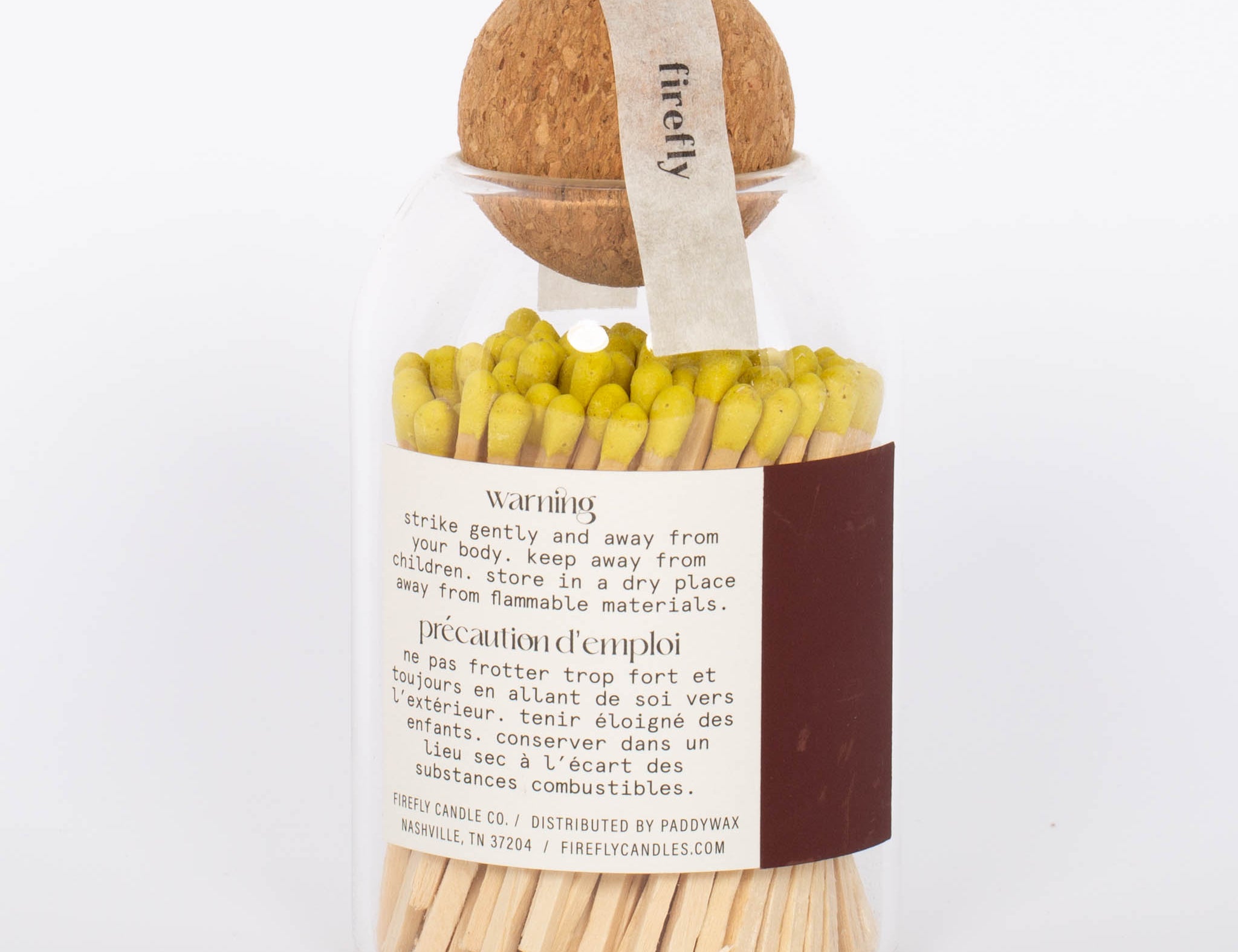 Yellow tip Safety Matches by Paddywax in clear jar and cork ball lid and match striker on back. 