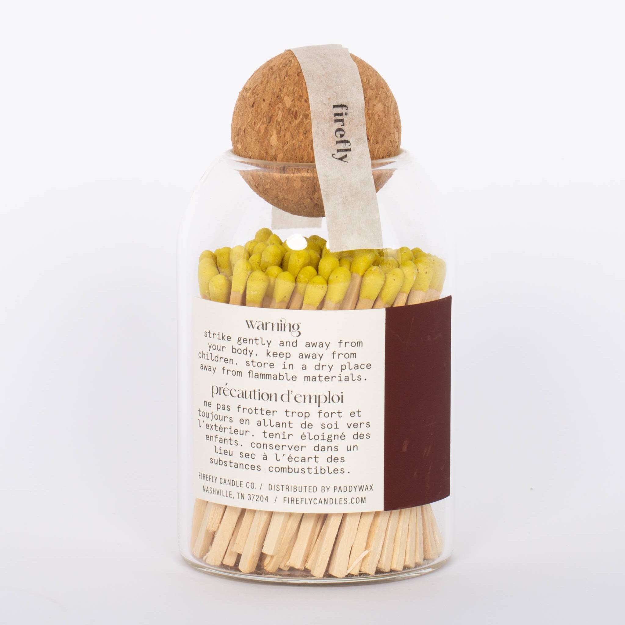Yellow tip Safety Matches by Paddywax in clear jar and cork ball lid and match striker on back. 