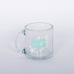 "Cluster Fuck Mug" Glass mug with blue type and white and yellow flower design.