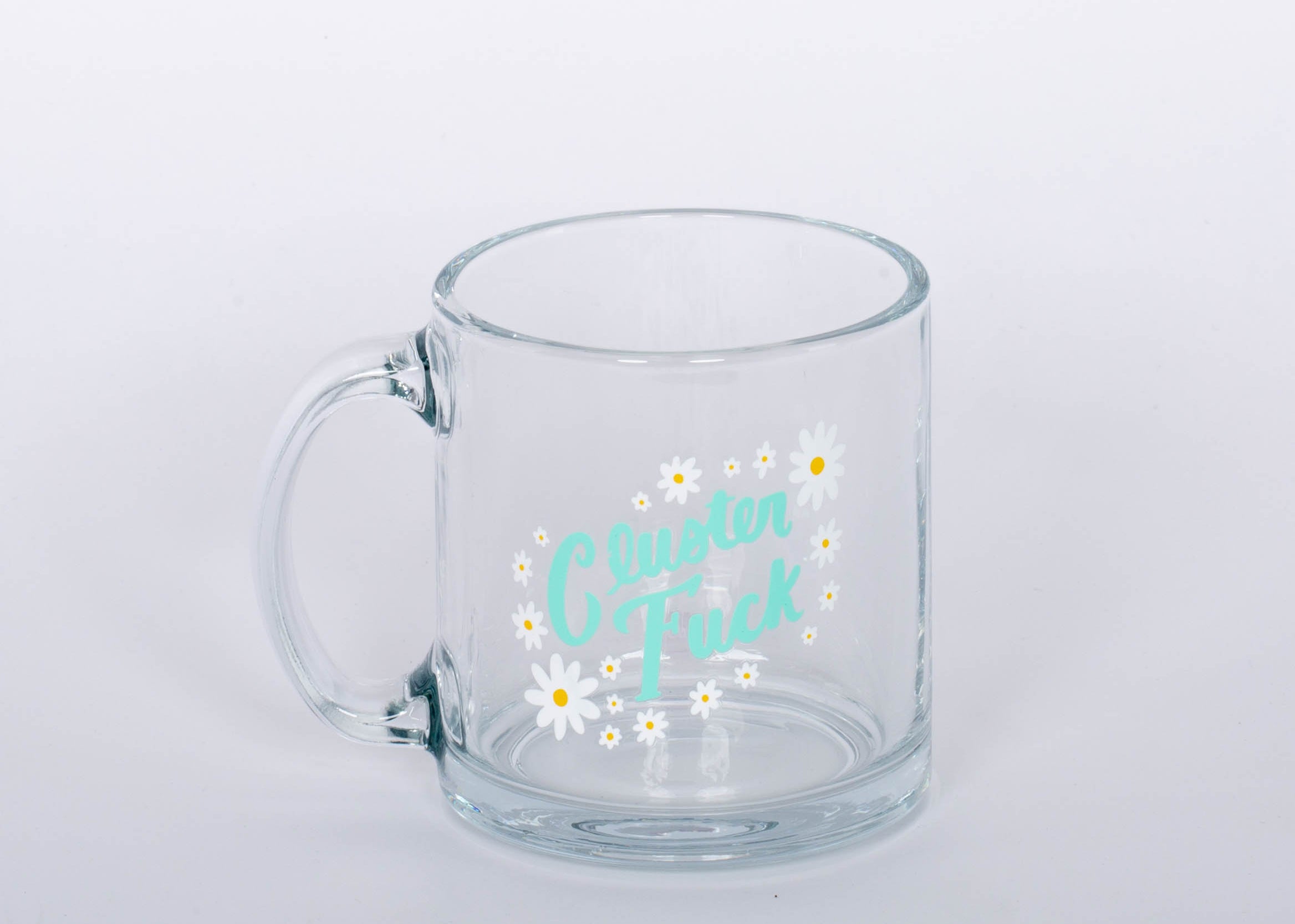 "Cluster Fuck Mug" Glass mug with blue type and white and yellow flower design.