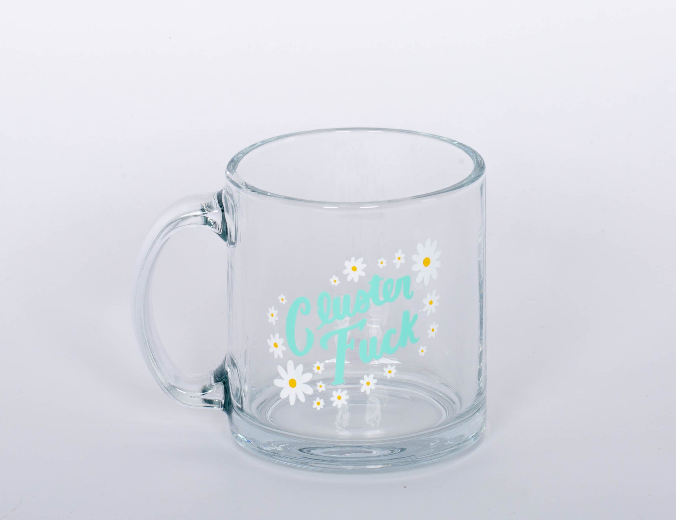 "Cluster Fuck Mug" Glass mug with blue type and white and yellow flower design.