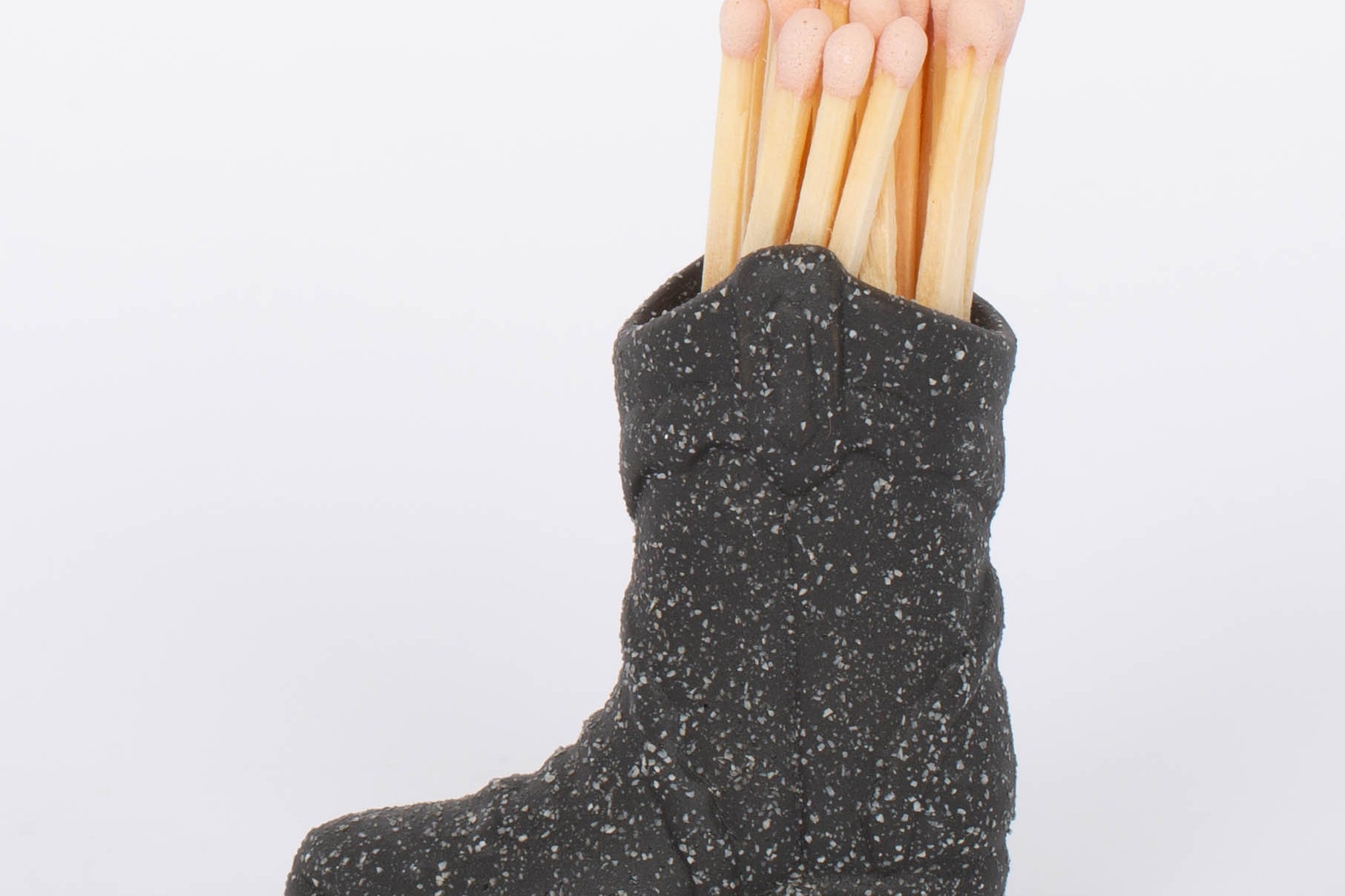 Black Cowboy Boot Match Holder This vintage-inspired ceramic cowboy boot match holder includes 25 safety matches that are easily lit with a strike on the bottom of the boot! After the safety matches run out, this holder is compatible with any match and can provide light by striking on the rough ceramic surface.
