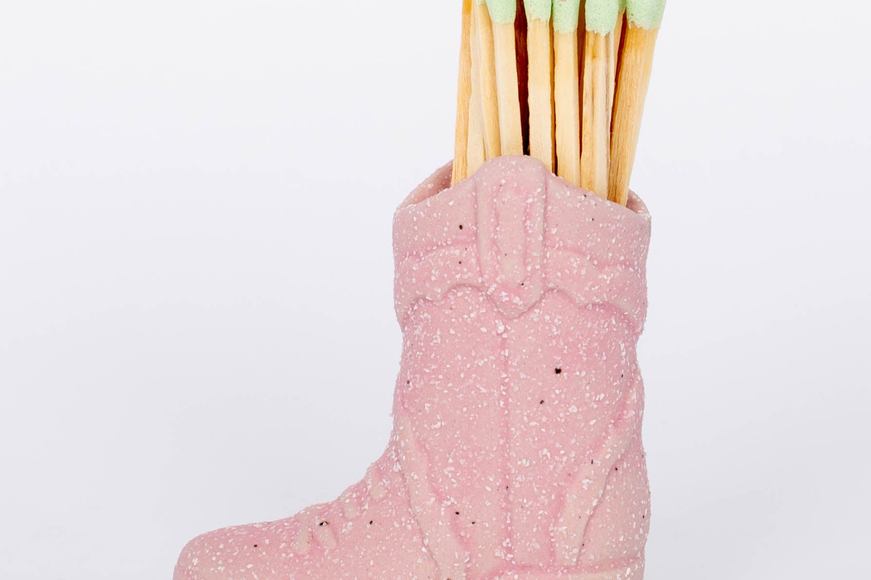 Pink Cowboy Boot Match Holder This vintage-inspired ceramic cowboy boot match holder includes 25 safety matches that are easily lit with a strike on the bottom of the boot! After the safety matches run out, this holder is compatible with any match and can provide light by striking on the rough ceramic surface.