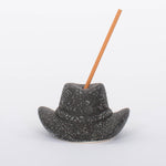 Black Cowboy Hat Incense Holder This vintage-inspired incense burner is on of our favorites! Including 100 fragrant incense sticks of Palo Santo Suede, this ceramic incense holder will keep your space burning with ambiance and fragrant tones.