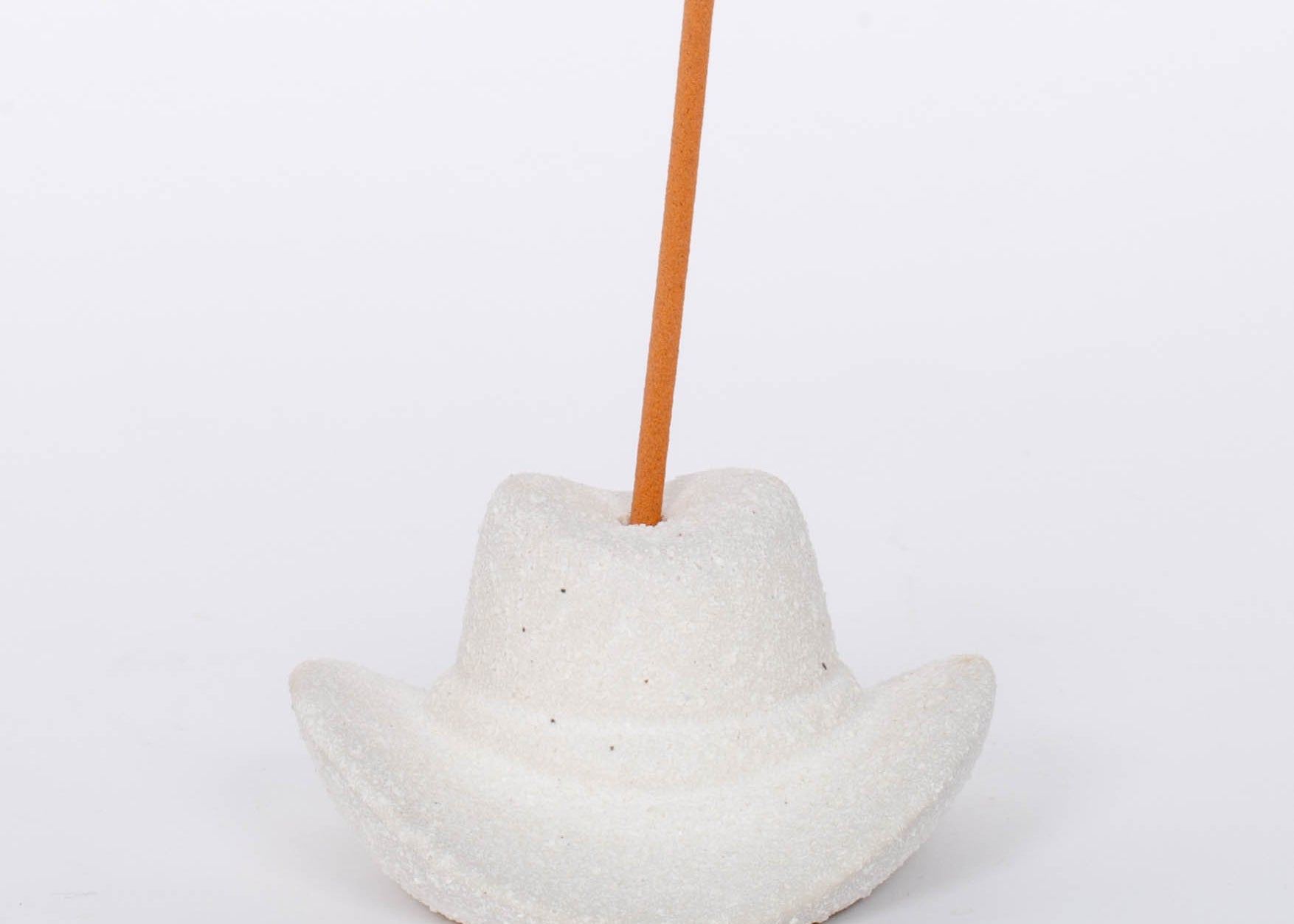 White Cowboy Hat Incense Holder This vintage-inspired incense burner is on of our favorites! Including 100 fragrant incense sticks of Palo Santo Suede, this ceramic incense holder will keep your space burning with ambiance and fragrant tones.