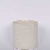 Modern striated ceramic Everest Pot in a matte white glaze.  White background.