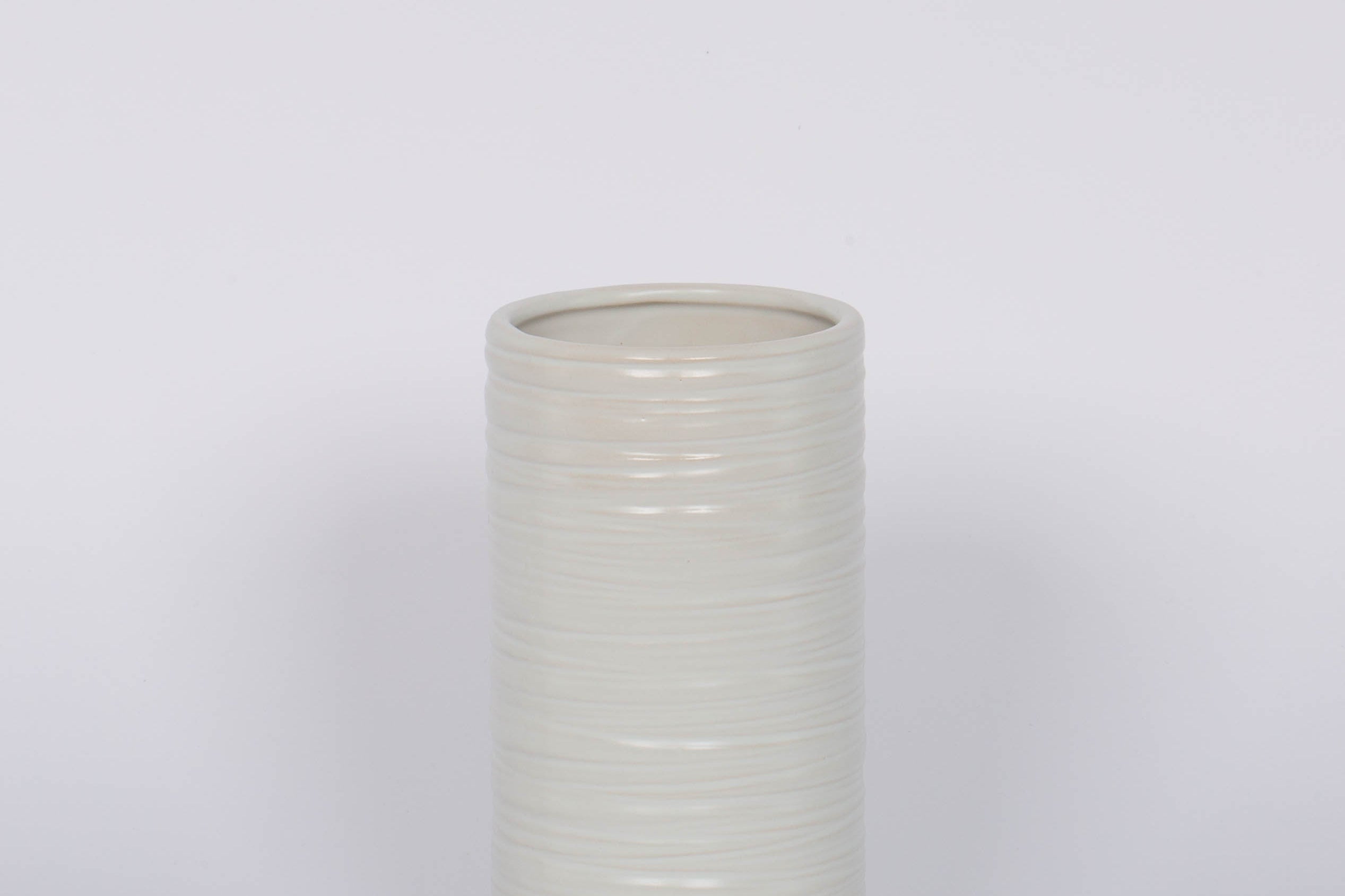 Modern and striated tall ceramic Everest Pot in a matte white glaze.White background.