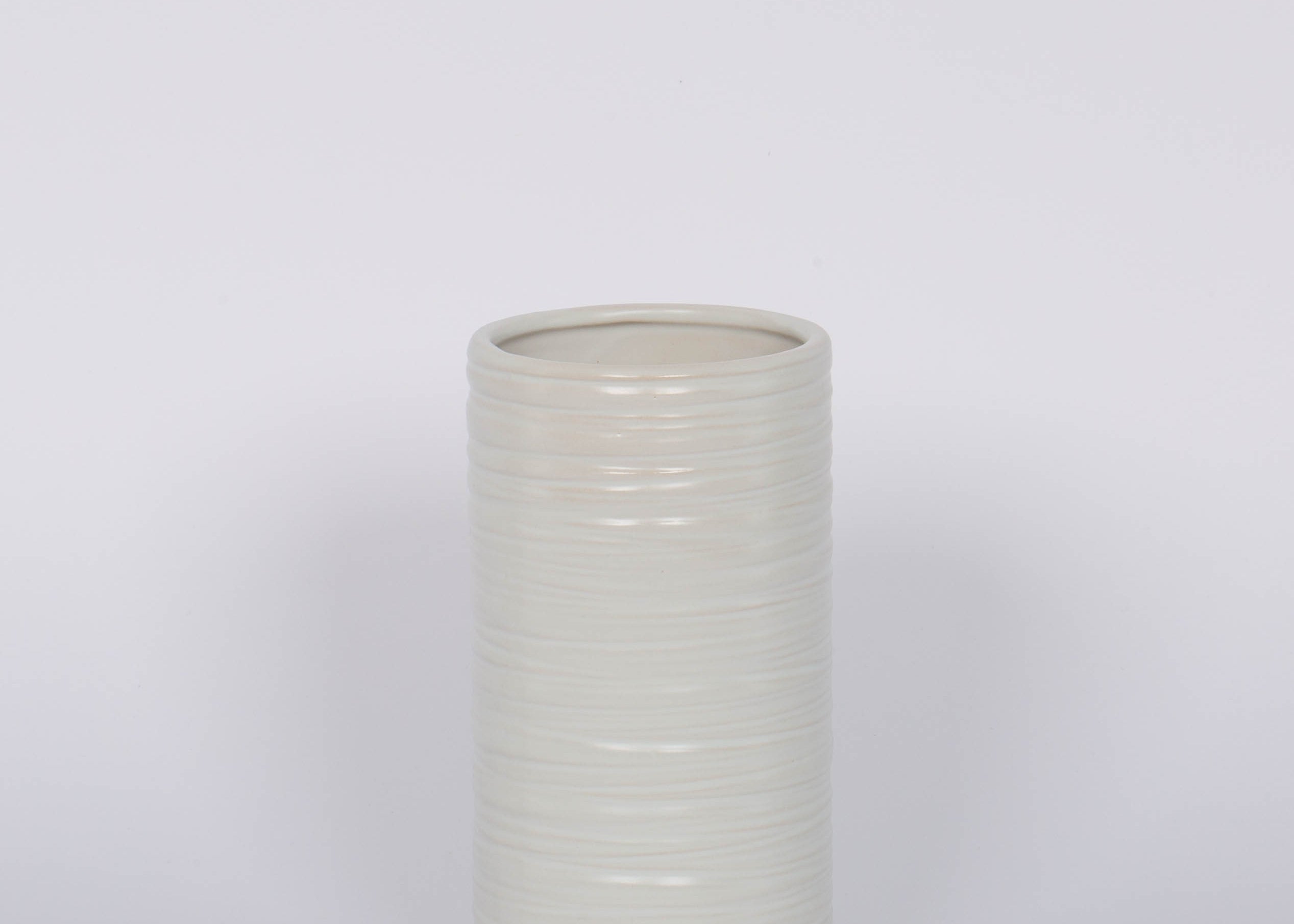 Modern and striated tall ceramic Everest Pot in a matte white glaze.White background.